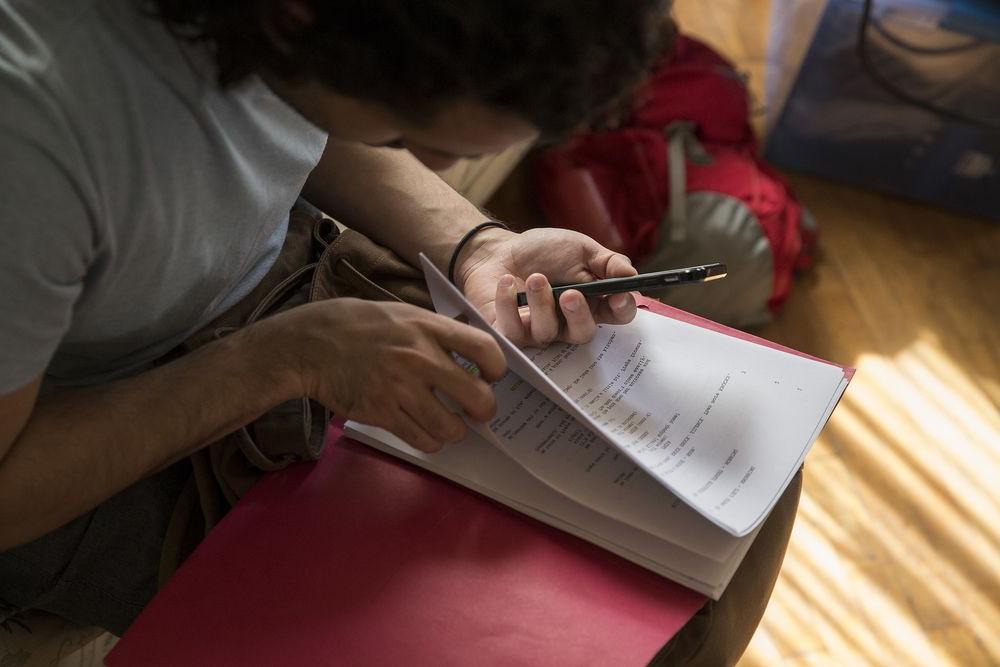 Person looking at a printed theater script. 